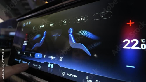 The interior of a premium car. Changes the climate control temperature on the display
