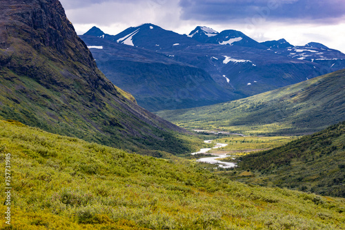 A beautiful Rapa river Rapadalen landscape with native plants. A mountain river from above in Sarek National Park, Sweden. Summer sceney of Northern Europe. photo