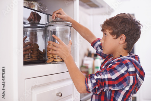 Картината върху платно Cookies, kitchen and snack for boy in house for steal, sneaky or sugar in pantry or cupboard for meal
