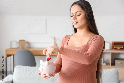 Young pregnant woman puttin...