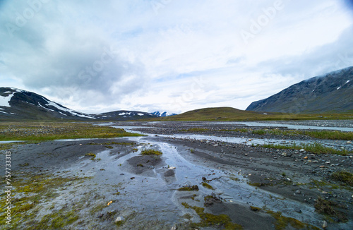 A beautiful summer landscape of mountain river in Sarek National Park, Sweden. Nordic wilderness scenery.