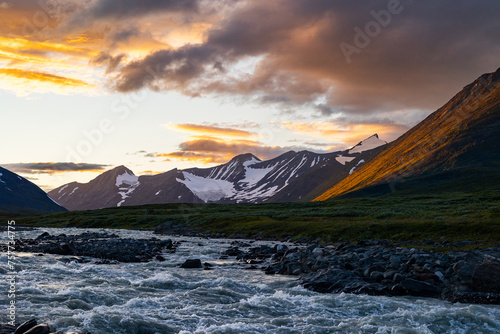 A wild, turbulent mountain river in the Sarek National Park, Sweden. A summer scenery with water in Northern Europe. photo