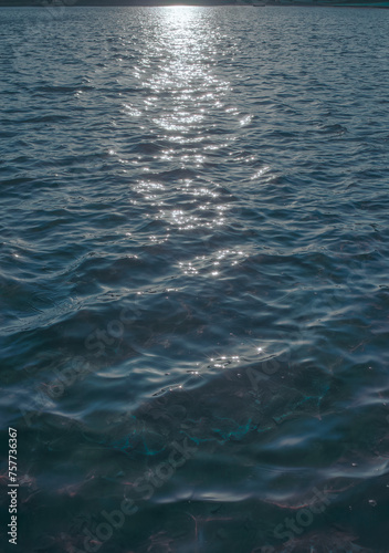 the sun is shining on the water near shore lines and water