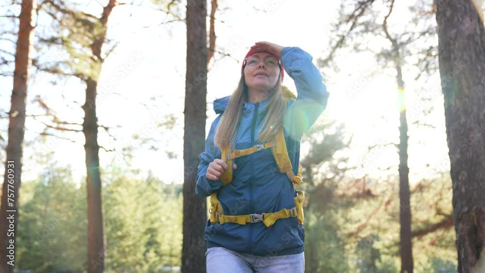 Tourism concept.girl walks along forest path. outdoor recreation. walk in forest park with backpack. walking in forest park. outdoor activities. hiking with backpack in forest park. healthy lifestyle