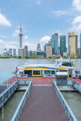 The landmark platform of the modern commercial city and the urban yacht wharf - the prosperous scene with the background of Shanghai Global Financial Center photo