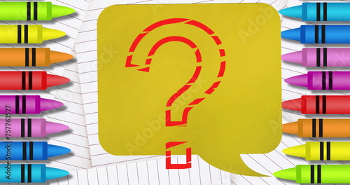 Question mark symbol over speech bubble against white lined paper and colorful crayons