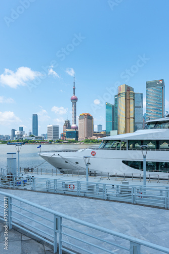 The landmark platform of the modern commercial city and the urban yacht wharf - the prosperous scene with the background of Shanghai Global Financial Center photo