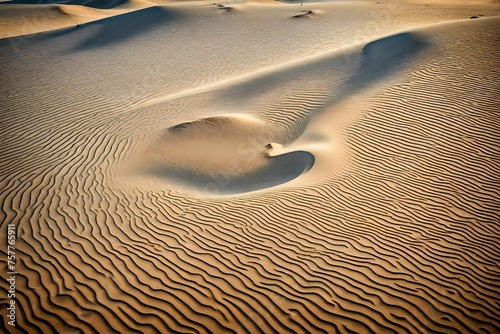 The wind-blown sand on a desolate dune forms a heart-shaped pattern that captures the essence of solitude in a huge expanse.