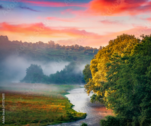 Beautiful summer scenery. Foggy morning view of Strypa river, Buchach town location, Ukraine, Europe. Stunning outddor scene of Ukrainian countryside. photo