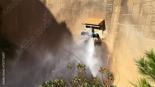 Closing of water outlet valve on dam wall. Howell Bunger valve opening. Closure of pressurized water outlet from dam wall.
