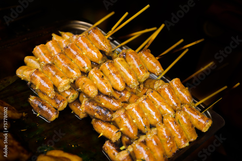 Charcoal grilled sausage or Sai Oua on a food stall photo