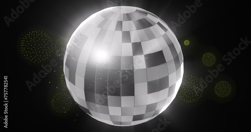 Image of disco ball over fireworks on black backrgound