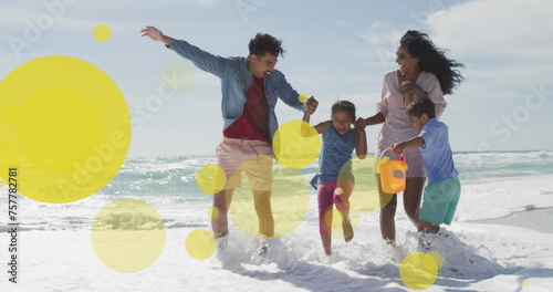 Biracial family enjoys a playful day at the beach