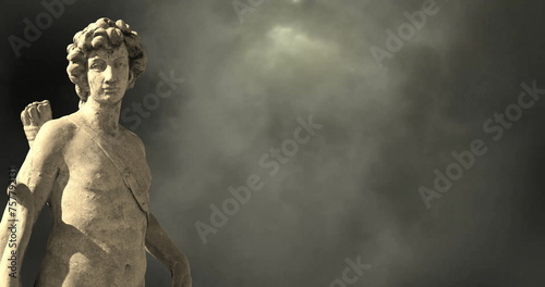 Image of gray sculpture of man over dark sky and clouds, copy space