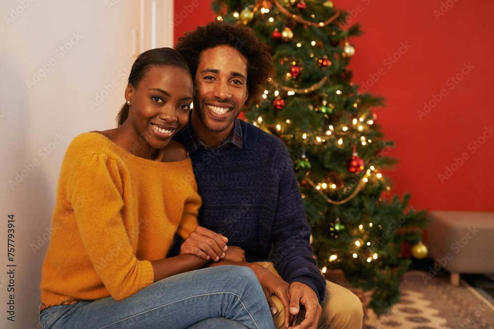 Couple, portrait and Christmas holiday at tree in home or vacation connection for festive season, love or decoration. Man, woman and face with lights in winter or marriage celebration, relax or break