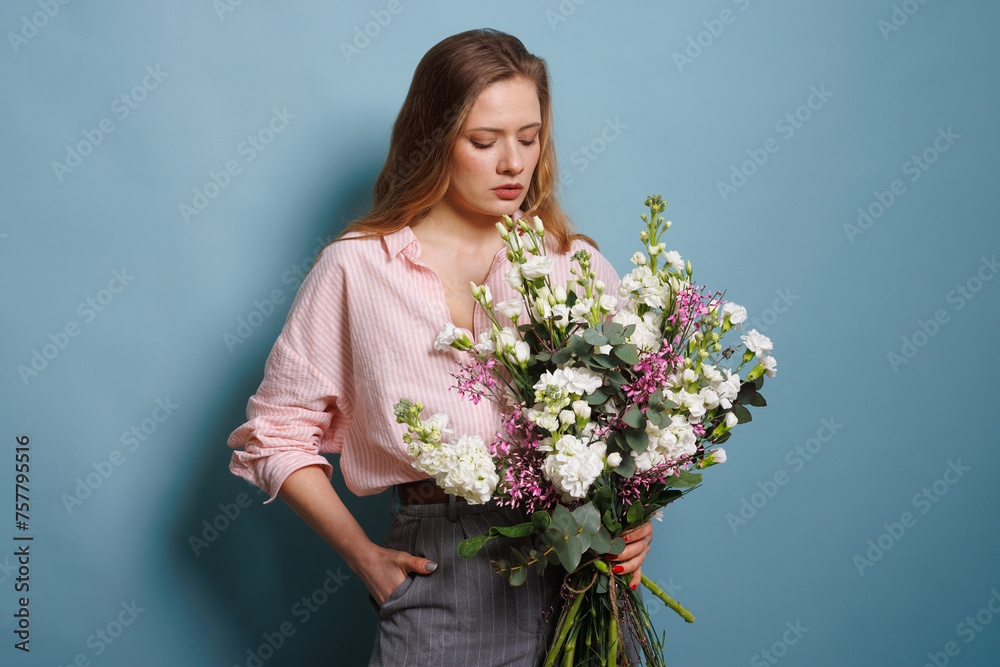 female florist makes a bouquet in a flower shop, spring bouquet female florist makes a bouquet in a flower shop, spring bouquet