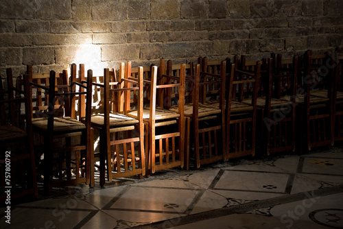 Empty church and crisis of religion concept with wooden chairs s photo