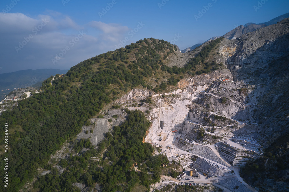 Carrara marble quarry in Italy with working bulldozers. Marble quarry top view. aerial panorama of marble quarries Carrara Italy.