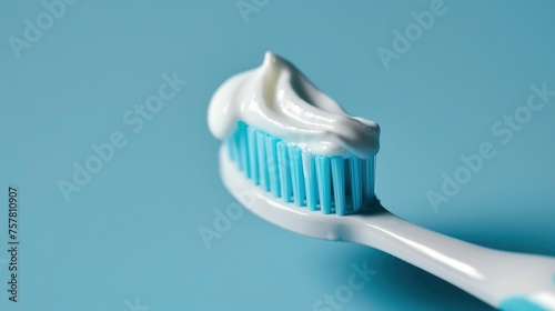 Toothpaste with toothbrush isolated on blue background.