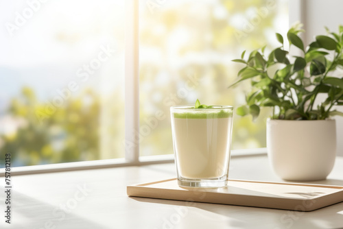 Refreshing matcha latte in a bright white kitchen on a summer morning with free copy space