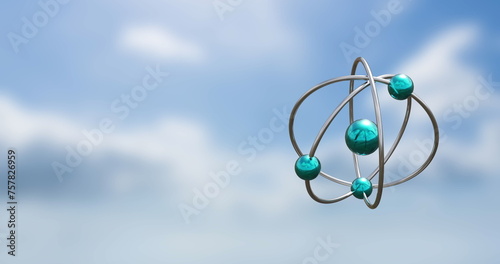 Image of atom models spinning over clouds onn blue background