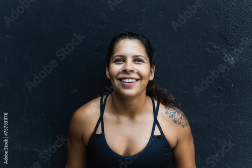 Portrait of a confident Hispanic latina female sports instructor with vision for healthy body