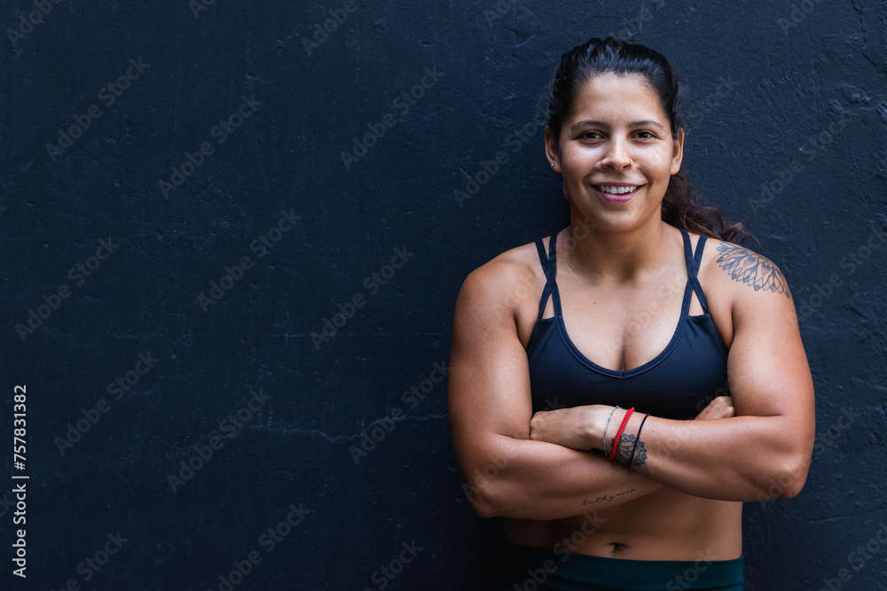 Obraz premium Woman fitness trainer portrait on a black background