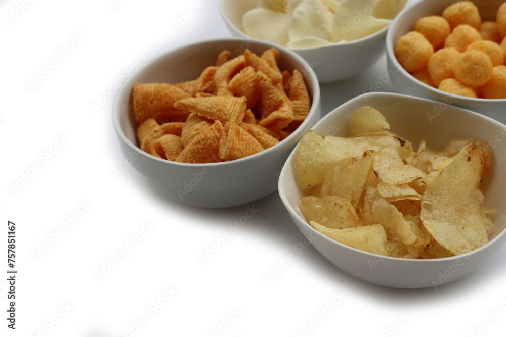 Top view of white ceramic bowls with different kind of chips isolated on white background Top view of white ceramic bowls with different kind of chips isolated on white background