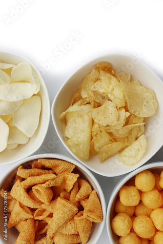 Top view of white ceramic bowls with different kind of chips isolated on white background