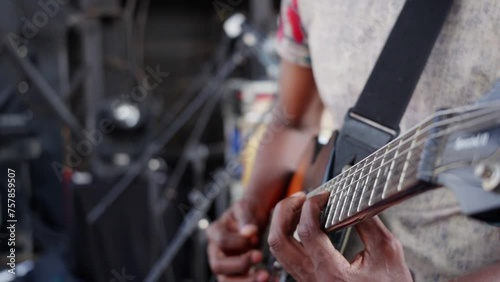 African man playing guitar in a band