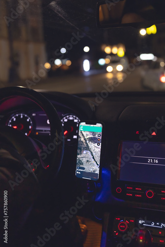 Navigator in a smartphone in a car at night, close-up.