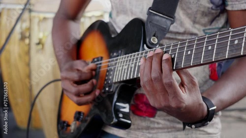 African man playing guitar in a band
