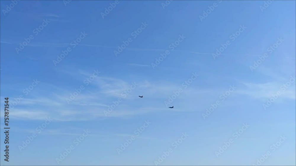 A military fighter aircraft flies in the blue sky A military fighter aircraft flies in the blue sky
