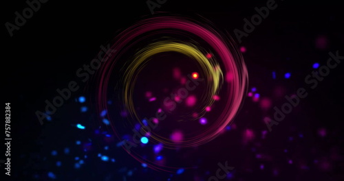Image of colourful light trails and spots forming circles on black background