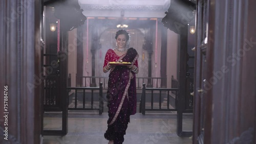 Sacred Beginnings: A Joyful Marathi Woman with a Puja Plate for Morning Tulsi Worship photo