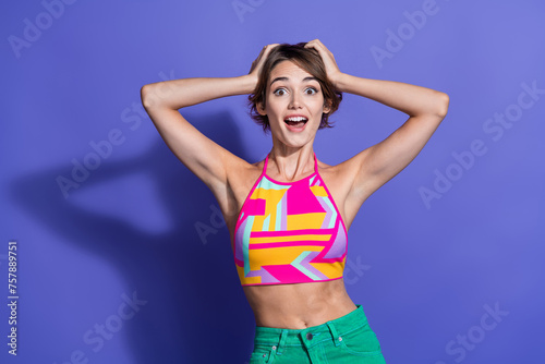 Photo of glad positive woman wear stylish clothes two arms touch head wow summer sale isolated on purple color background