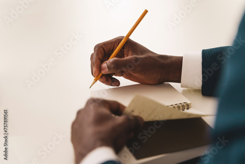 Businessman Taking Notes at Meeting - Executive jotting down ideas photo