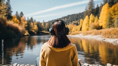 Music therapy, harmony, mental health concept. Pretty young woman enjoying music with headphones outdoors. Woman wearing headphones enjoying music and good vibes  © Charisia
