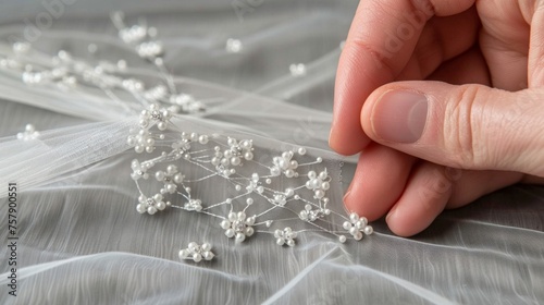 A close-up of delicate handiwork on white bridal lace  showcasing intricate beading and embroidery.