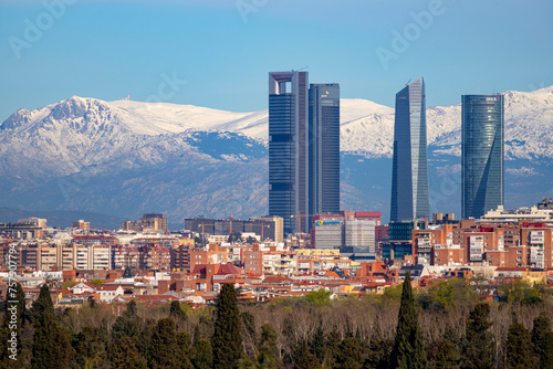 Sierra de Guadarrama. Mountain system seen from the city of Madrid with the recently snow-covered mountains covering the entire top of the mountain range in a white blanket. Skyline next to mountains. photo
