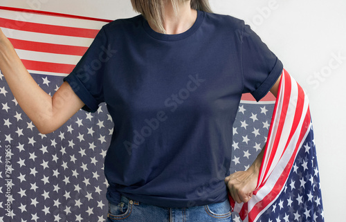 Woman with USA flag and blank navy blue t shirt. Blank girls Blue tshirt 4th of July USA Independence Day. Copy space for your design here