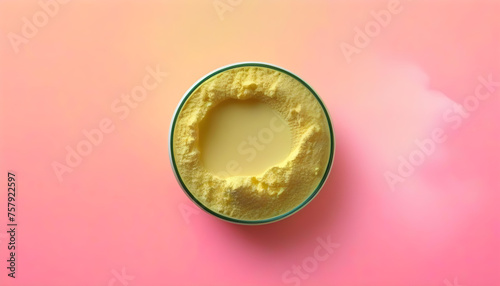 Yellow collagen powder on a pink background.