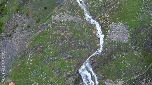 Aerial shot of Cascata di Stroppia with Lago Niera, lush greenery, and rugged terrain, daylight photo