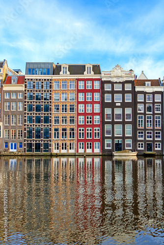Photography Traditional Dutch construction buildings on Damrak canal in Amsterdam in winter