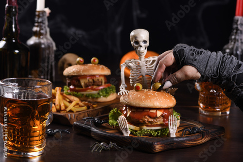 The witches hand holds the eye of Monstera Burger. Perfect Halloween Party appetizer