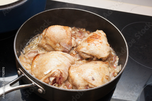 Chicken thighs being cooked in a pan