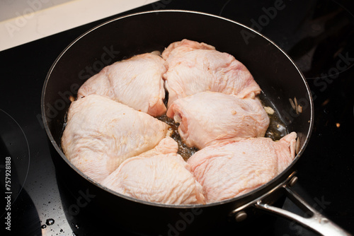 Batch cooking chicken thighs in a pan
