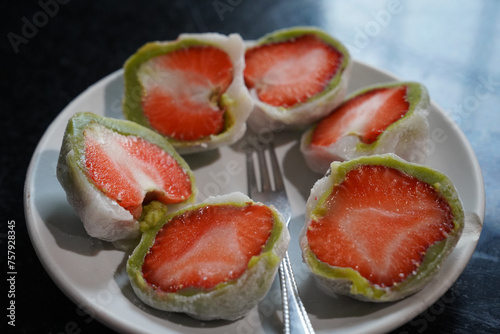 daifuku strawberry in green sticky jelly desert in refrigerater is delicious 