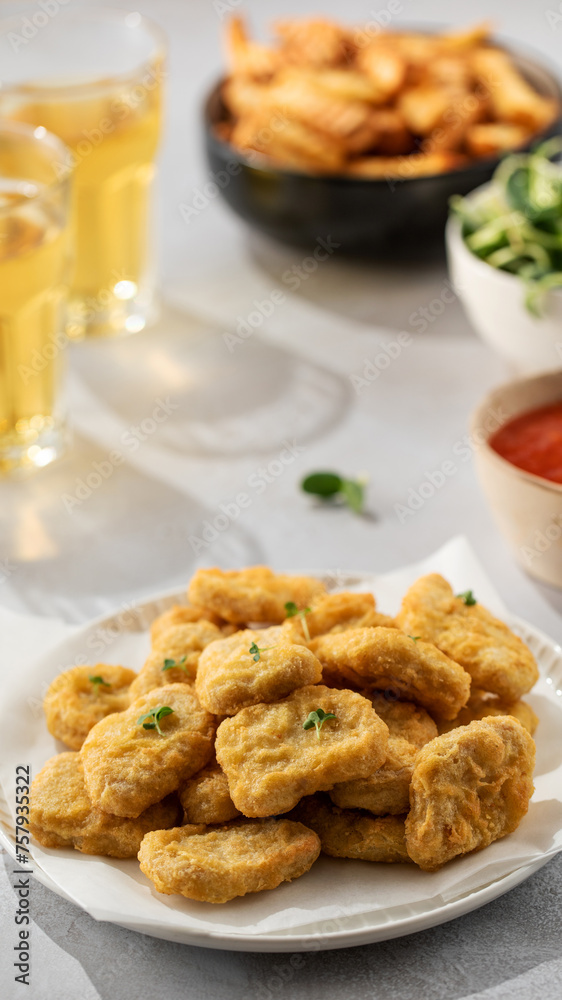 There is a plate of crispy chicken nuggets on the table. Fast food, fast food restaurant. There is a plate of crispy chicken nuggets on the table. Fast food, fast food restaurant.