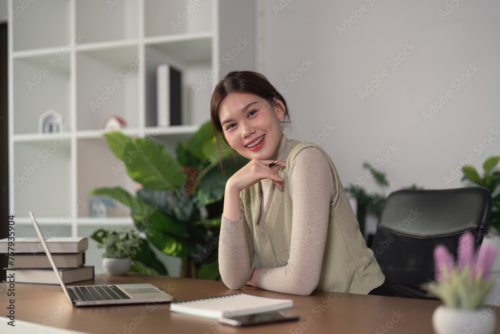 Woman asian creative in home office and laptop for research in remote work, social media or blog in apartment. Freelance at desk with computer writing email, website post and online chat in house Woman asian creative in home office and laptop for research in remote work, social media or blog in apartment. Freelance at desk with computer writing email, website post and online chat in house